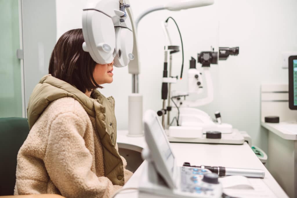 Teenage girl having an eye exam at optometrist centre